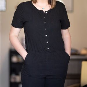 Black jumpsuit with brass buttons